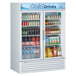 A Turbo Air white refrigerated merchandiser with drinks and beverages behind two glass doors.