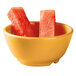 A bowl of watermelon slices in a yellow GET Diamond Mardi Gras melamine bowl.