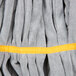 A close up of a yellow and grey Unger SmartColor microfiber mop head with yellow stitching.