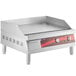 An Avantco stainless steel countertop electric griddle with red controls and a red handle.
