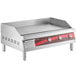 An Avantco stainless steel countertop griddle with red knobs.