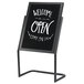 A black Aarco double pedestal sign with white text that says "Welcome Open Come On" with white background.
