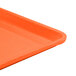 An orange Cambro dietary tray with a white background.