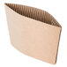 A natural Kraft corrugated cardboard coffee cup sleeve with a fold.