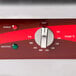 A close-up of a red and white Avantco temperature control dial.