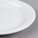 A close up of a Tuxton Colorado bright white narrow rim china plate.