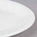 A Tuxton bright white oval china platter with a narrow rim.