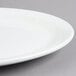 A close up of a Tuxton Colorado bright white china platter with a narrow rim.