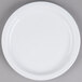 A Tuxton Colorado bright white narrow rim china plate on a gray surface.