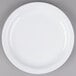 A Tuxton Colorado white plate with a narrow white rim on a gray surface.