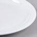 A close up of a Tuxton Colorado white plate with a narrow white rim.