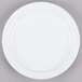 A Tuxton Colorado white china plate with a narrow white rim on a gray surface.