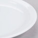 A Tuxton Colorado white china plate with a narrow white rim.