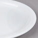 A close up of a Tuxton Colorado bright white narrow rim China plate.