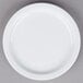 A Tuxton Colorado white plate with a narrow white rim on a gray surface.