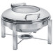 An Eastern Tabletop stainless steel round chafer with glass lid on a stand.