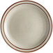 An Acopa white stoneware plate with a brown speckled rim.