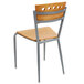 A Lancaster Table & Seating natural finish cafe chair with metal legs.