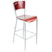 A red and silver Lancaster Table & Seating mahogany finish cafe bar stool with a metal frame.
