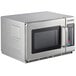 A Solwave stainless steel commercial microwave with a glass door.