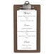 A dark brown Menu Solutions clipboard with a menu on it.