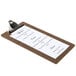 A dark brown Menu Solutions clipboard with a menu on it.
