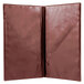 A close-up of a burgundy and brown leather folder with two open pages.