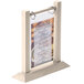 A Menu Solutions almond wood flip top table tent with a menu in a frame.
