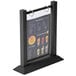 A Menu Solutions black wood flip top table tent with plastic sheet and rings holding a menu on a table.