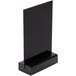 A black Menu Solutions table sign board with a black wood base.