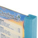 A sky blue wooden Menu Solutions table tent on a table.