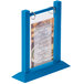 A Menu Solutions blue wood flip top table tent on a table with a menu inside.