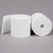 A close-up of rolls of white Point Plus thermal paper.