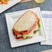 A sandwich on an EcoChoice Compostable sugarcane square plate.