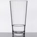 A clear Get Revo plastic mixing glass on a table.