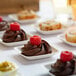 EcoChoice compostable sugarcane square appetizer plates with chocolate desserts on them.