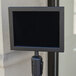 A black Aarco horizontal stanchion sign frame on a pole.