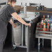 A woman opening a Beverage-Air dual zone kegerator to dispense beer.
