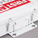 A white metal Medique first aid kit box with red and white text.