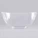 A clear plastic bowl on a white surface.