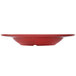 A red GET Etchedware melamine bowl on a white table.