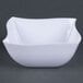 A white Fineline plastic bowl with a curved edge.
