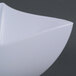 A close up of a white Fineline Wavetrends plastic bowl with a curved shape.