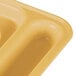 A close-up of a yellow Cambro co-polymer compartment tray.