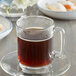 A glass mug of Caffe de Aroma Midnight Silk coffee on a saucer.