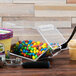 A Cal-Mil stackable topping dispenser with colorful candies and an ice cream scoop.