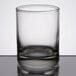 A close up of a clear Libbey shot glass on a reflective surface.