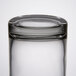 A close up of a Libbey clear glass votive holder with a white background.