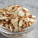 A glass bowl of Regal sliced almonds on a table.