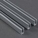 A group of metal profiles, one with three grey metal strips.